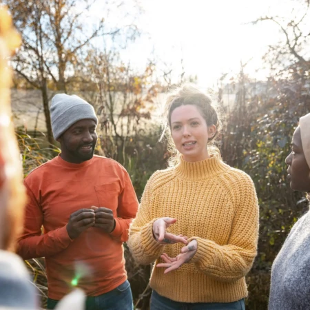 People gathered round talking in a garden