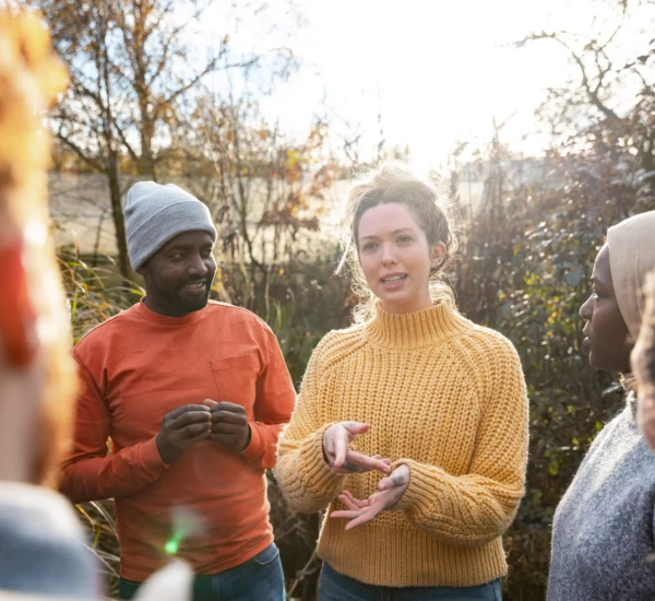 People gathered round talking in a garden