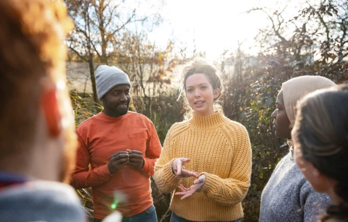People gathered round talking in a garden