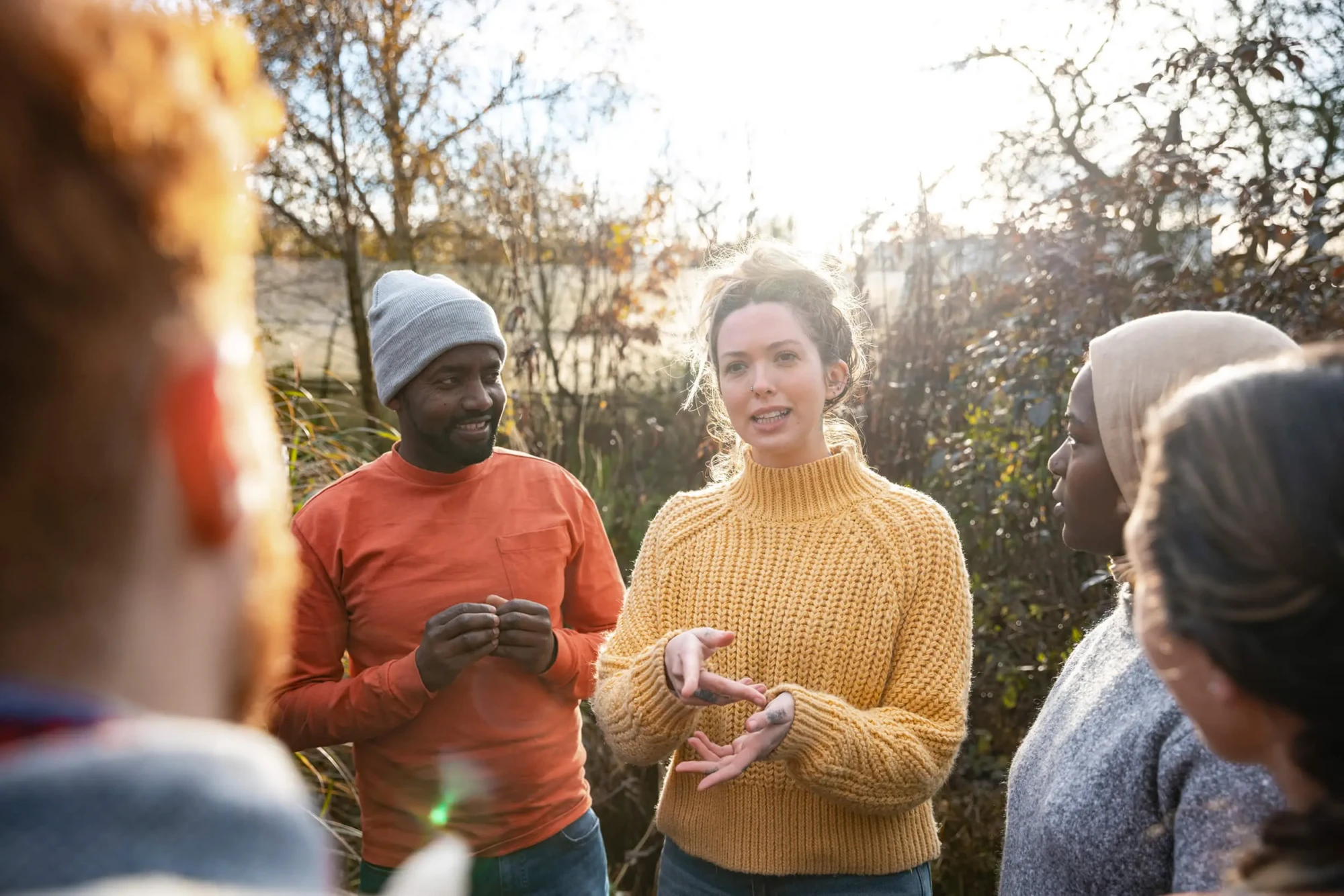 People gathered round talking in a garden