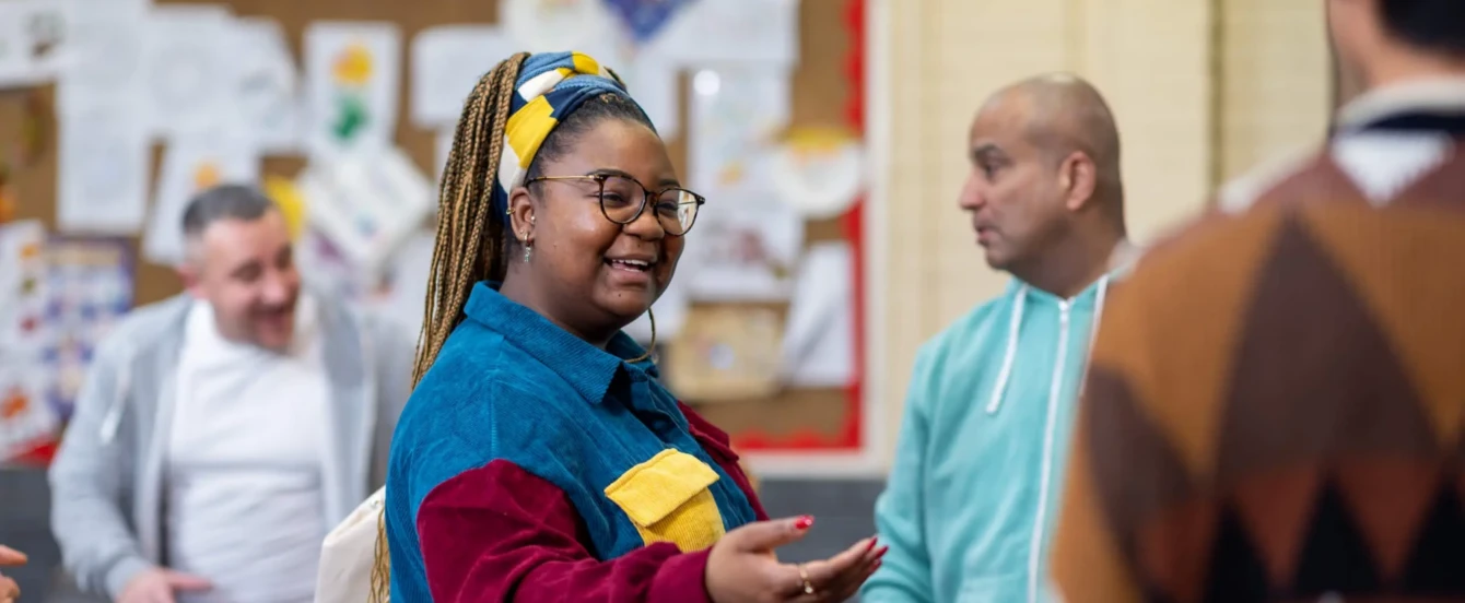 Woman smiling with hand outstretched