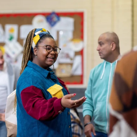 Woman smiling with hand outstretched
