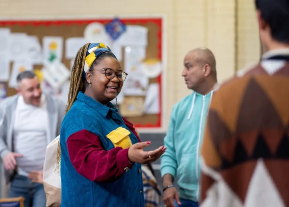 Woman smiling with hand outstretched
