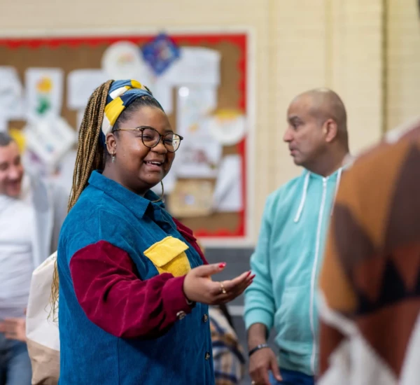 Woman smiling with hand outstretched